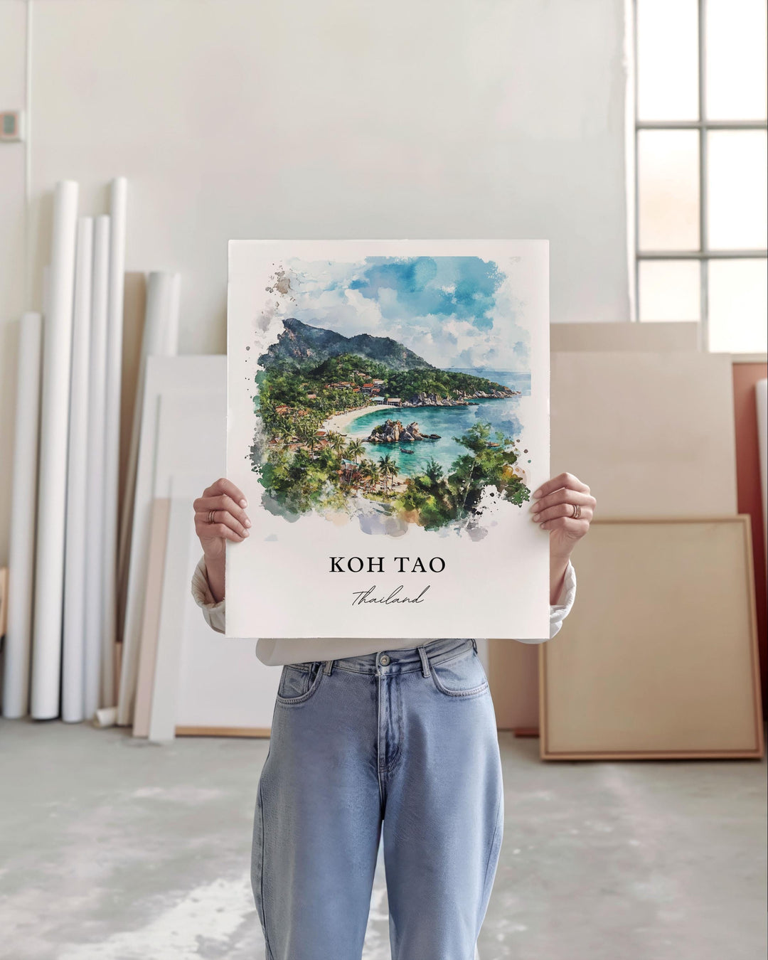 a woman holding up a picture of a tropical island