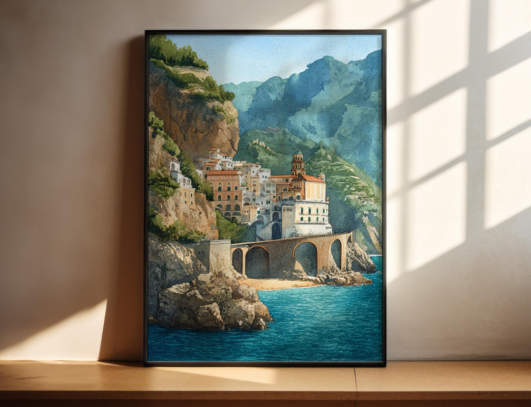 Amalfi Coast Italy watercolor wall art in a black frame captures a cliffside village above the sparkling sea with vibrant coastal beauty.