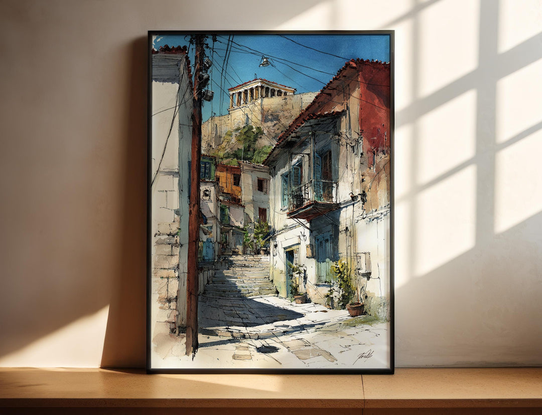 Athens Greece watercolor wall art in a black frame captures the neighborhood's charming stone streets beneath the Acropolis with vibrant detail.