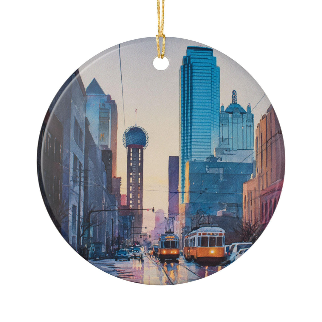 Dallas Texas holiday ornament with a gold string, featuring the skyline, Reunion Tower, blue skyscrapers, and warm sunset watercolor details.