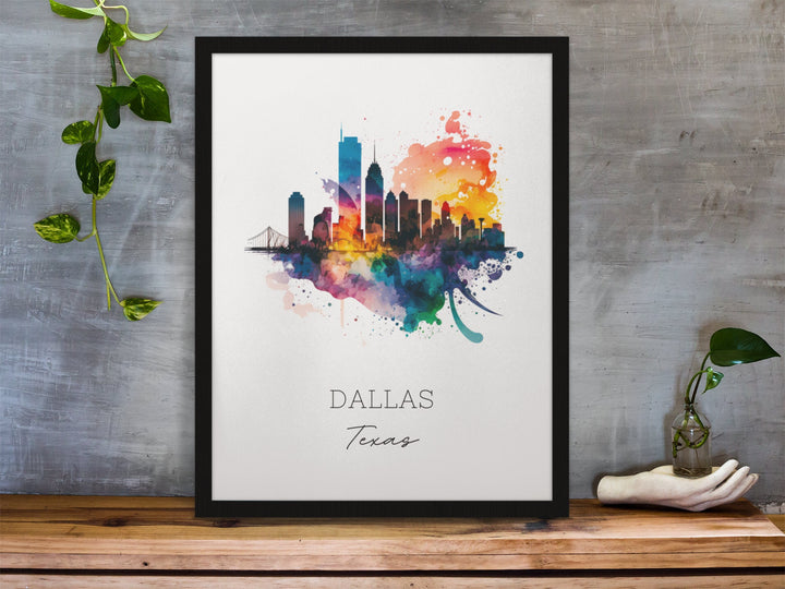 Dallas Texas watercolor wall art in a black frame featuring a colorful skyline silhouette, vibrant watercolor splashes, a white background, and gray lettering.
