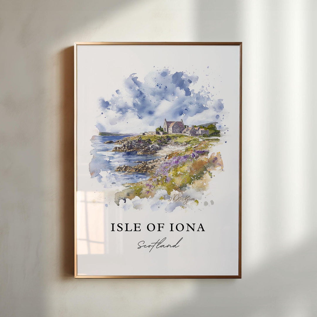 Isle of Iona Scotland watercolor wall art in a gold frame featuring a rugged coastline, historic abbey, soft blue skies, and blooming coastal wildflowers.