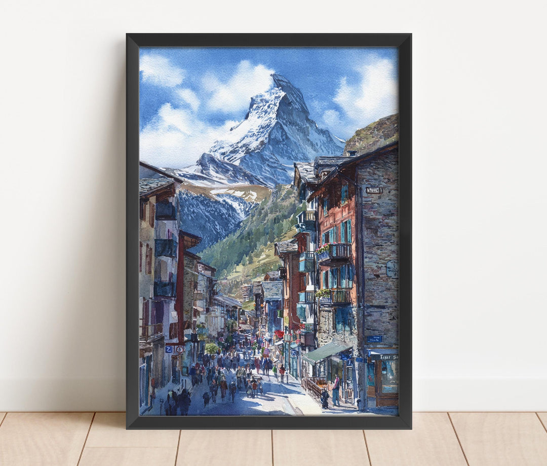 Watercolor Matterhorn Zermatt Village Street wall art in a black frame featuring the iconic Matterhorn towering above a charming Swiss alpine village, a beautiful Switzerland print.