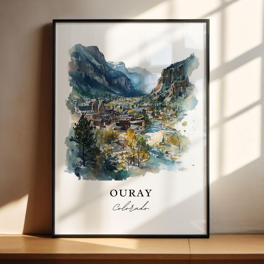 Ouray Colorado watercolor wall art in a black frame featuring a mountain valley, winding river, charming downtown, and soft alpine colors.
