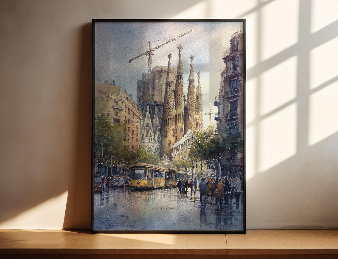 Sagrada Família Barcelona Spain watercolor wall art in a black frame captures the iconic basilica and classic tram on a lively avenue.