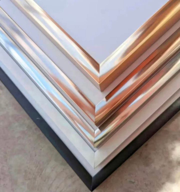 a stack of metal sheets sitting on top of a table