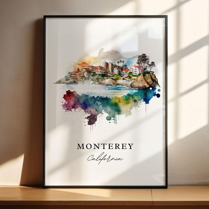 Vibrant watercolor travel art print of Monterey, California featuring coastal buildings, palm trees, and rocky cliffs blending into a colorful rainbow abstract paint splash, displayed in a black frame with window shadow lighting